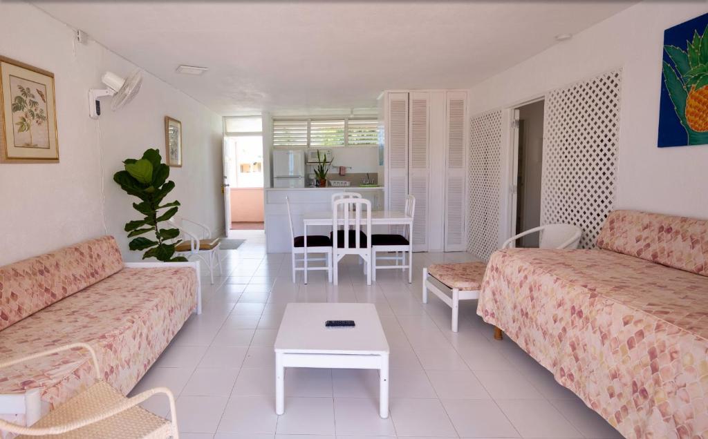 a living room with two couches and a table at The Monteray Hotel in Christ Church