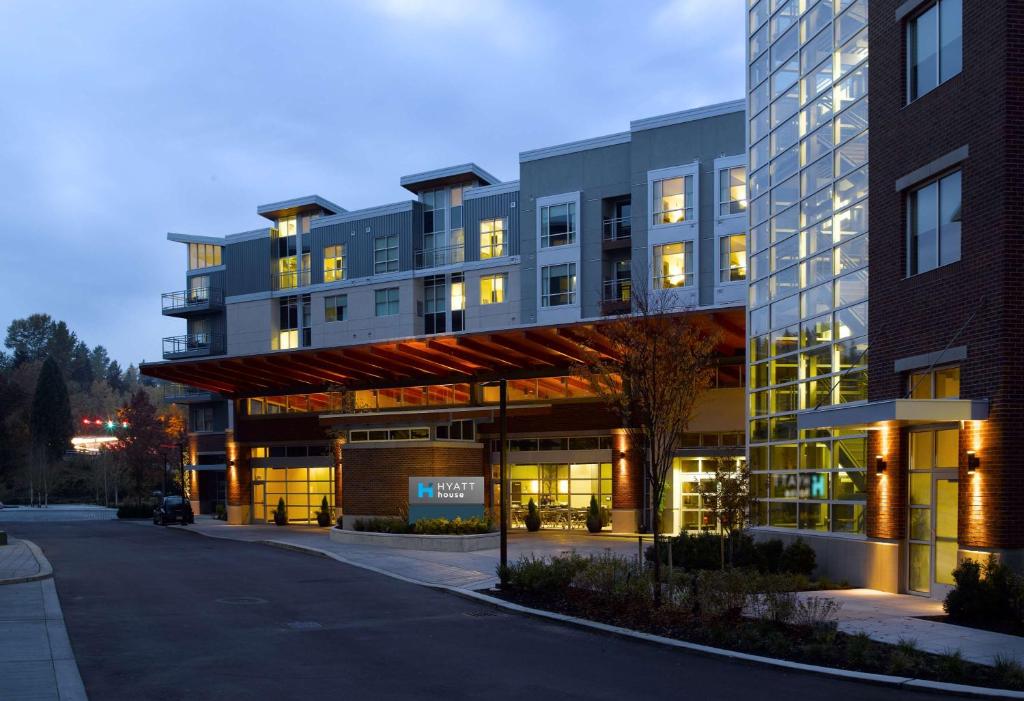 a large building with lights on in a street at Hyatt House Seattle/Redmond in Redmond