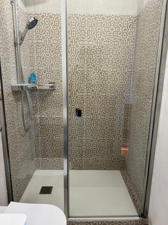 a shower with a glass door in a bathroom at VILLA TARA in Quercianella