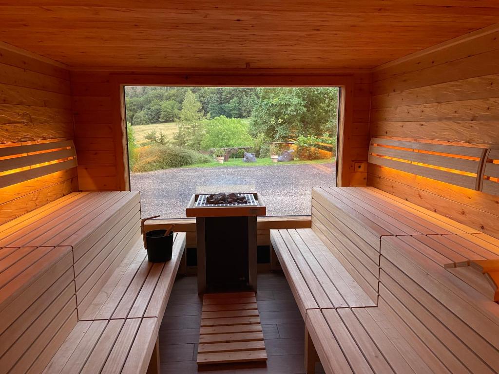 a sauna with two benches and a table in it at Hotel - Restaurant Bastenhaus in Dannenfels