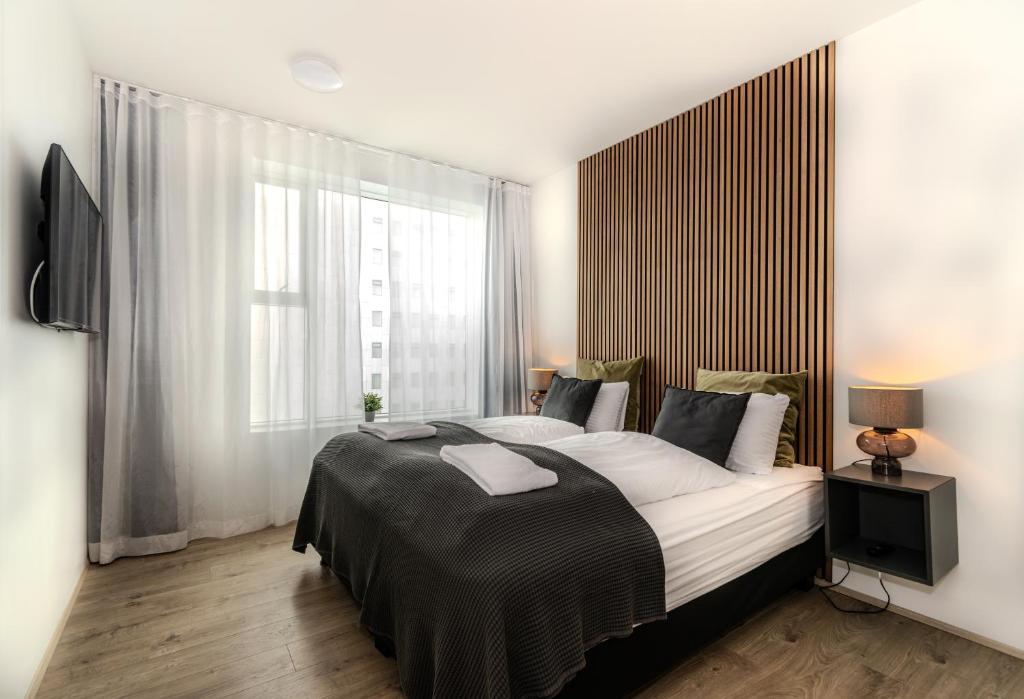 Postel nebo postele na pokoji v ubytování Sif Apartments by Heimaleiga