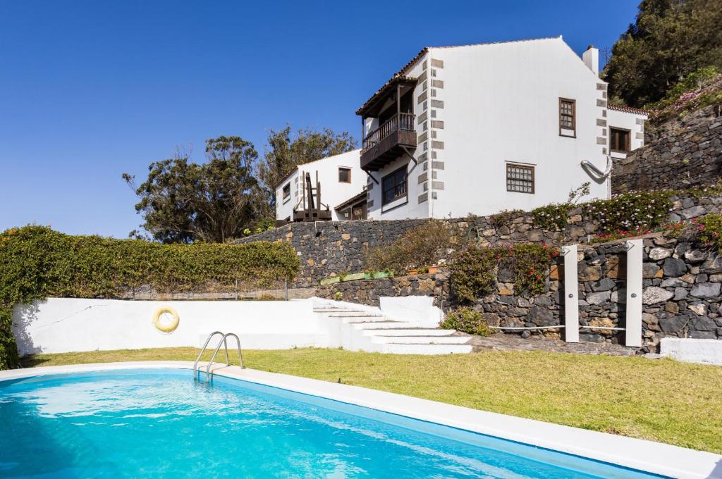 a house with a swimming pool in front of a house at Finca Los Geranios in Tegueste