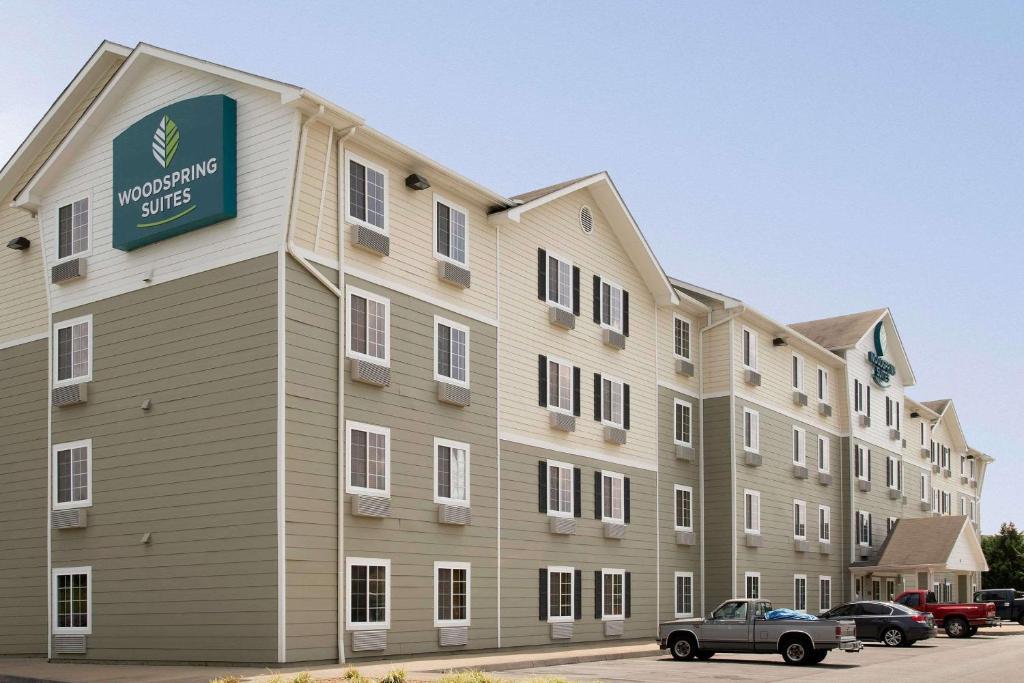 a large apartment building with a sign on it at WoodSpring Suites Johnson City in Johnson City