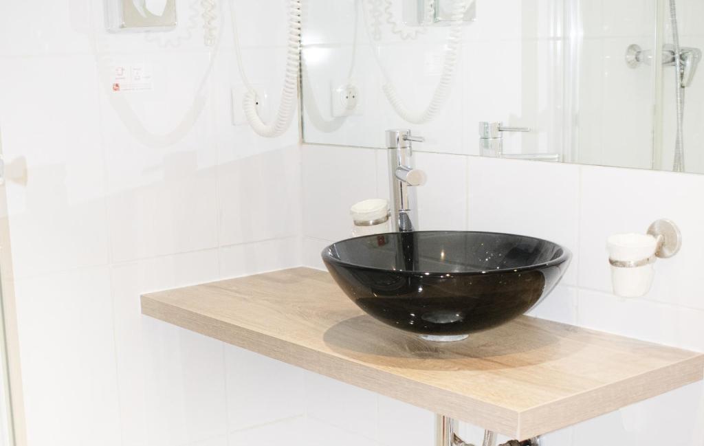 a black bowl sink on a counter in a bathroom at Tiercé Hotel in Cagnes-sur-Mer