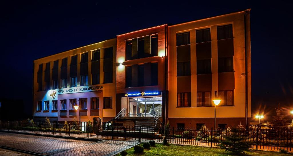 a building with lights in front of it at night at Apartamenty-Europejska in Suwałki