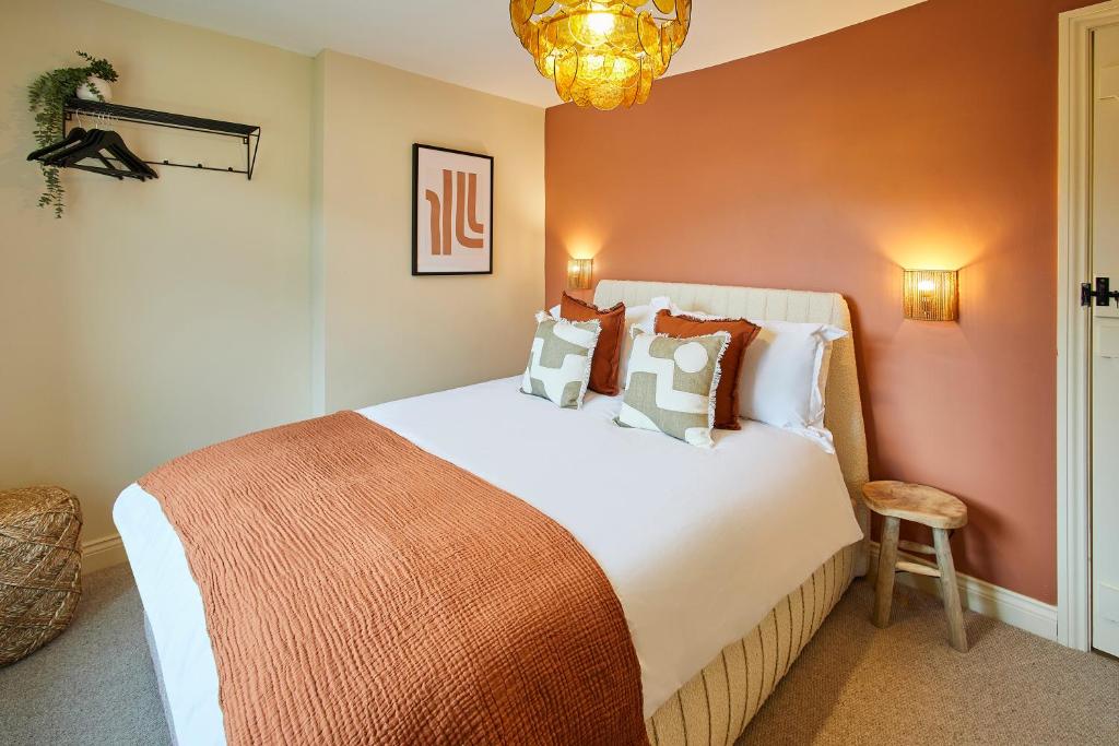 a bedroom with a large bed and a chandelier at Host & Stay - Cinnamon Cottage in Barnard Castle