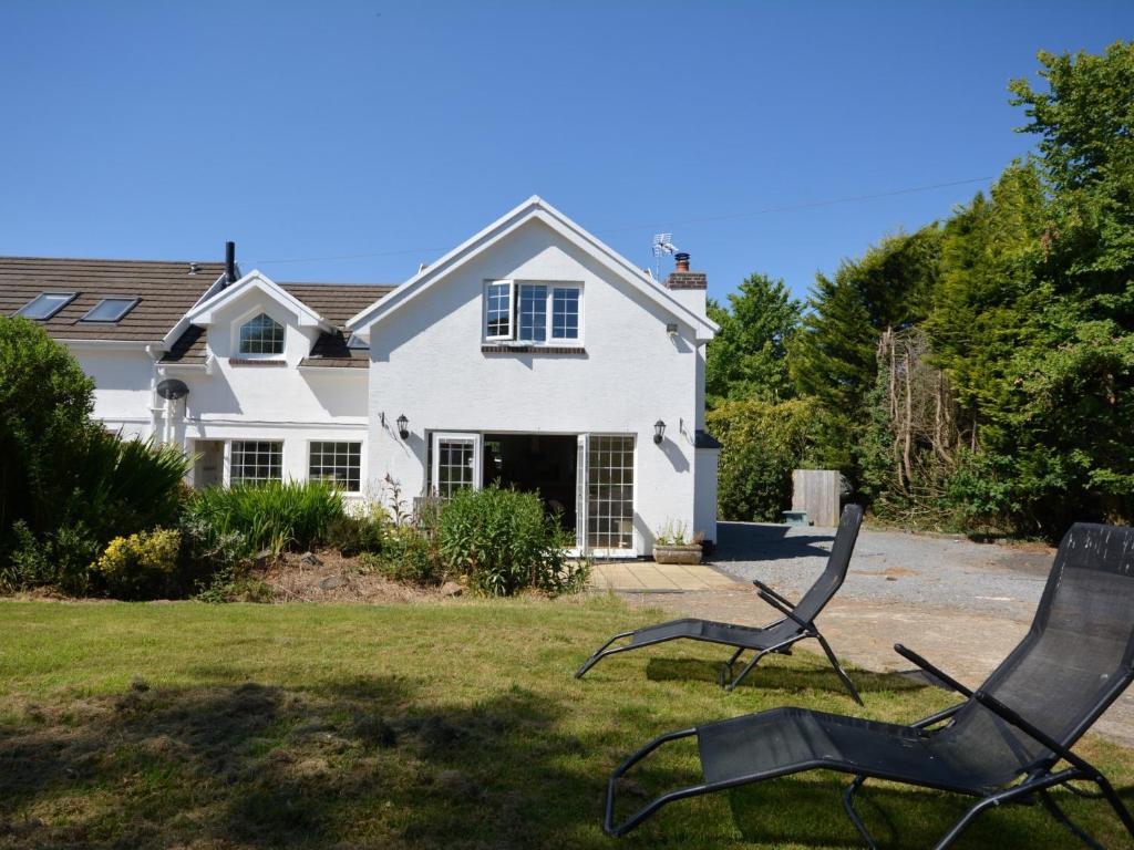 two lawn chairs in front of a house at 2 Bed in Cosheston 60704 in Cosheston