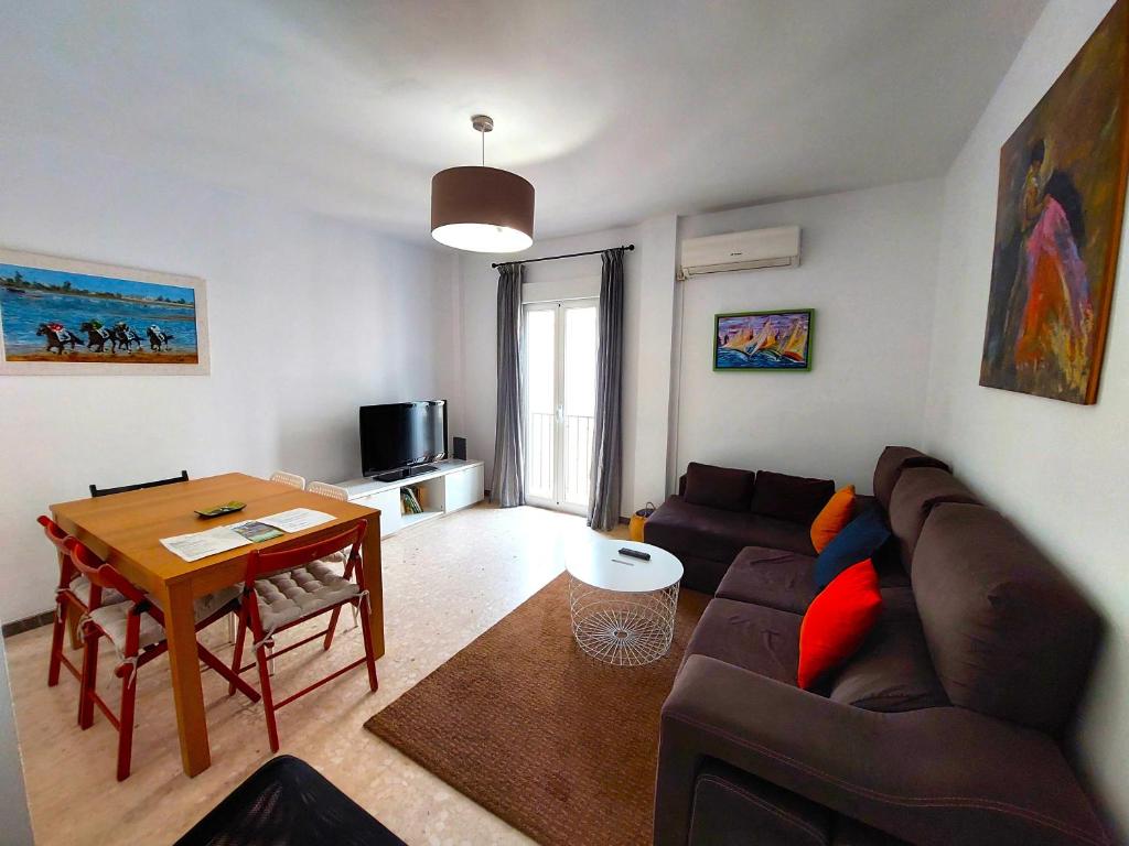 a living room with a couch and a table at Enladrillada Apartment in Seville