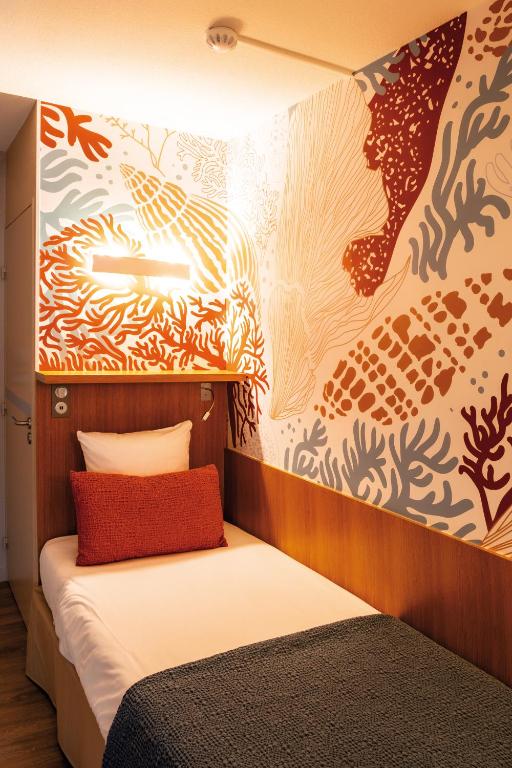Cama ou camas em um quarto em Club Vacances Bleues Les Jardins De l'Atlantique