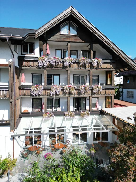 a building with flower boxes on the balconies at Bergidyll in Oberstdorf