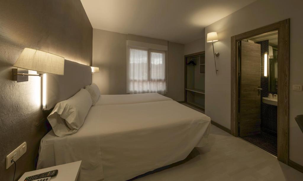 Postel nebo postele na pokoji v ubytování Hotel Bilbi