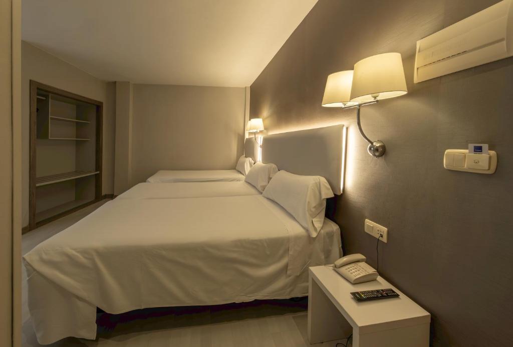 Postel nebo postele na pokoji v ubytování Hotel Bilbi
