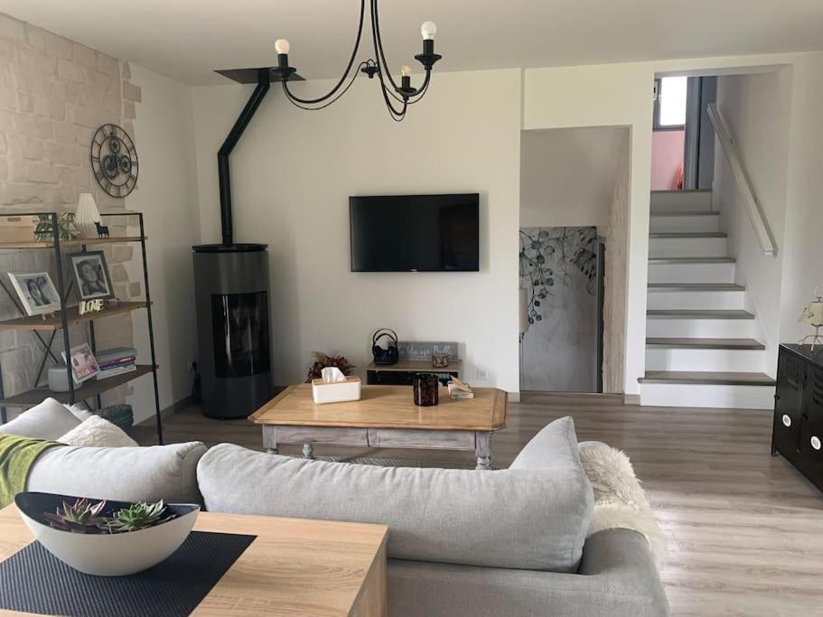 a living room with a couch and a table at Villa au coeur de la vallée in Thyez