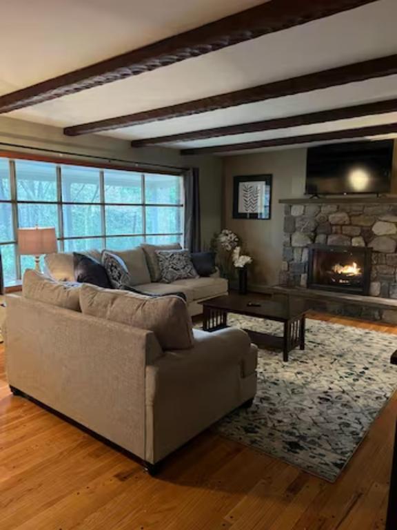 a living room with a couch and a fireplace at Mountain Road Lodge in Tannersville