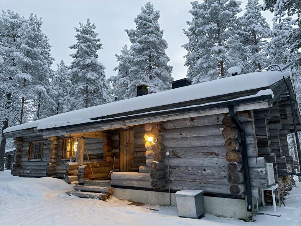 a log cabin with snow on top of it at Villa Poronperä in Kuusamo