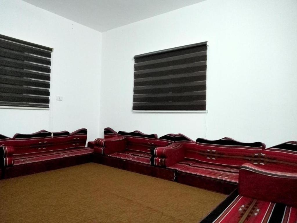 an empty auditorium with red seats in a room at عجلون- راس منيف in Ajloun