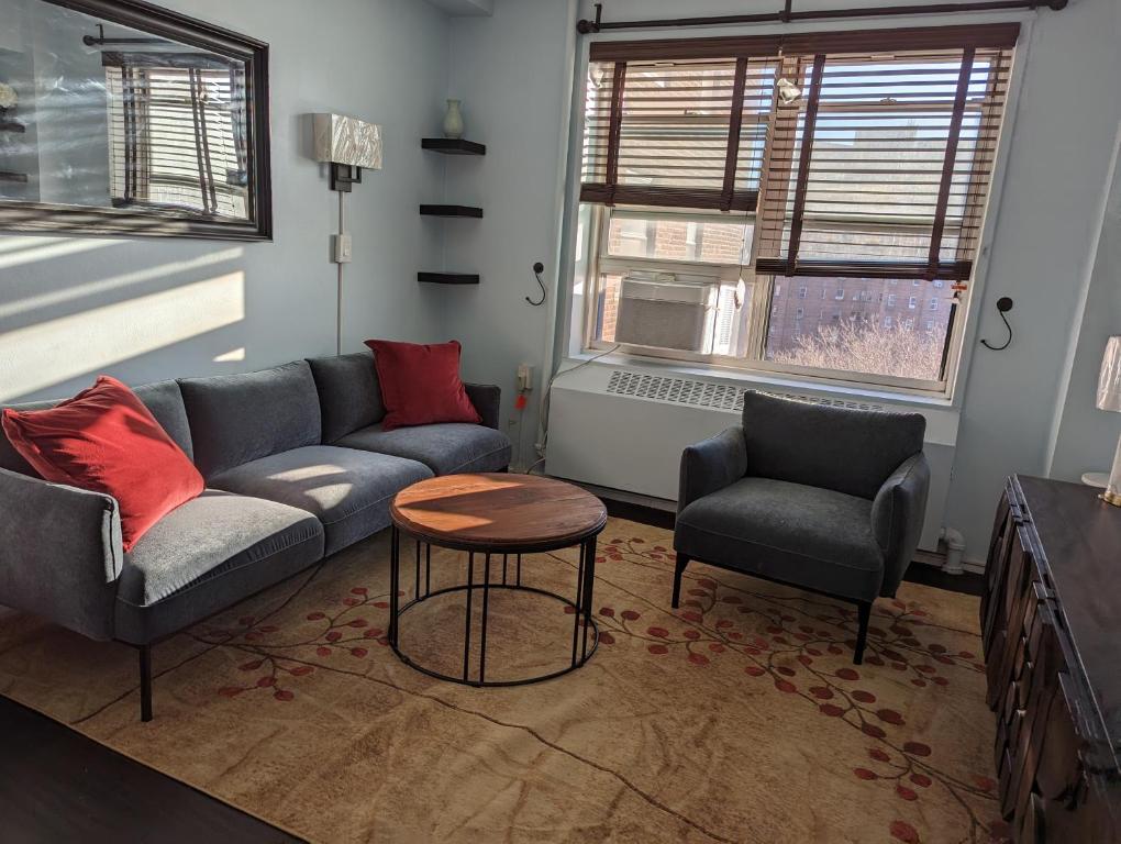 a living room with a couch and two chairs and a table at Fully renovated Manhattan gem in New York