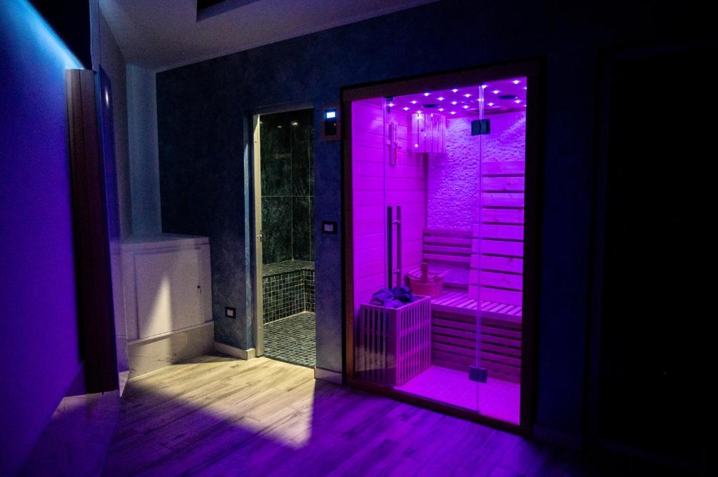 a bathroom with a pink lighted shower in a room at AETERNA SUITES SPA Apartment in Terracina