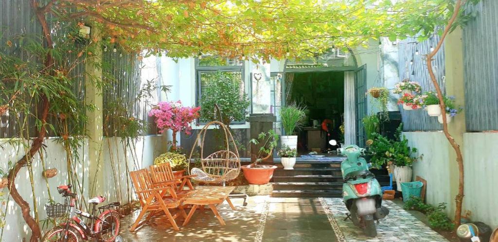 a house with a scooter parked in a garden at Romantic house with garden in Bien Hoa in Bùi Tiếng