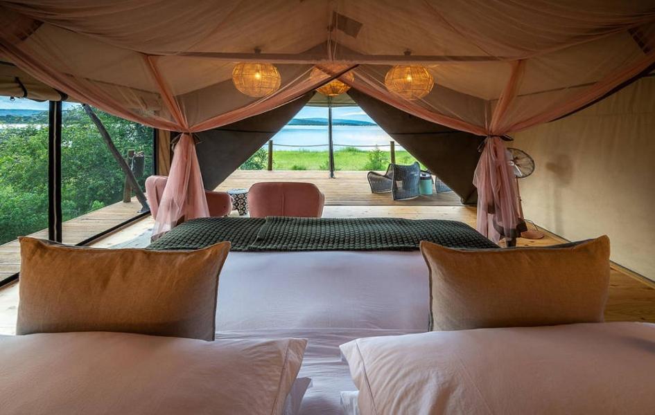 a bedroom with two beds in a tent at GOOLO guesthouse in Jinja