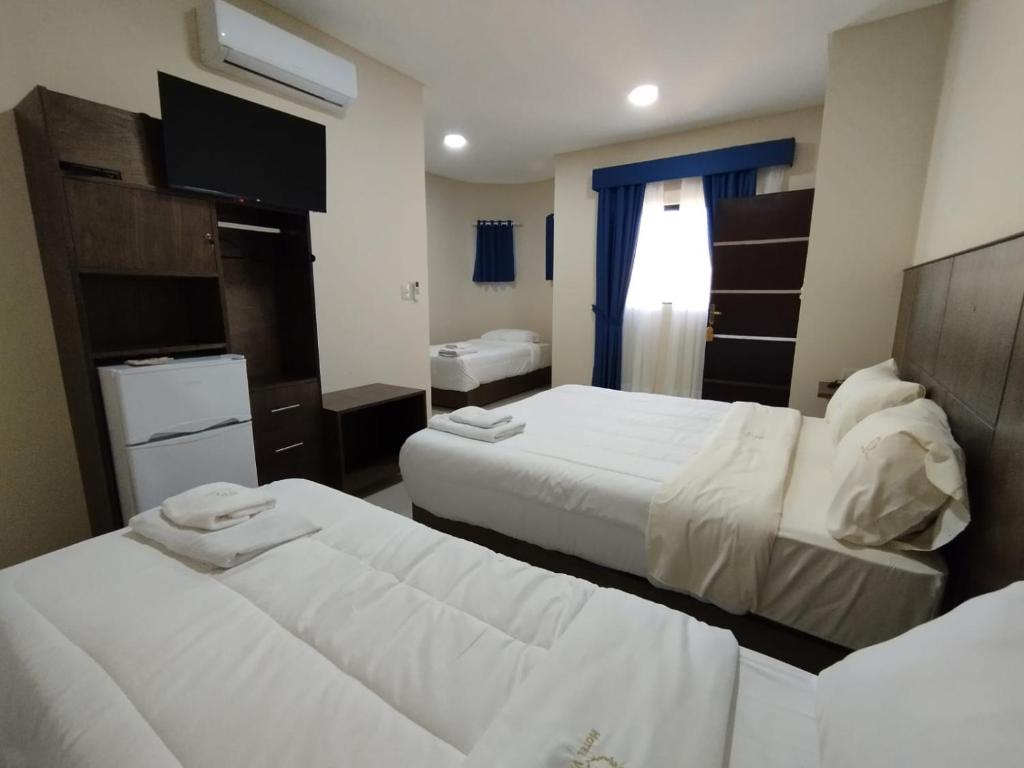 Postel nebo postele na pokoji v ubytování Hotel Villa