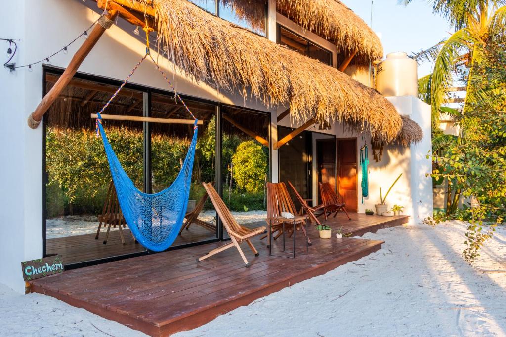 a resort with a hammock on a deck at Ca Nikte Cabañas in El Cuyo