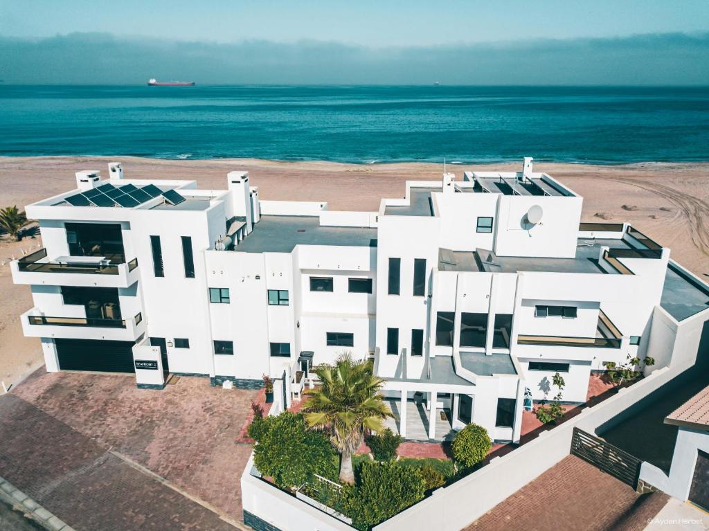 an aerial view of a white building on the beach at SeafrontC in Swakopmund