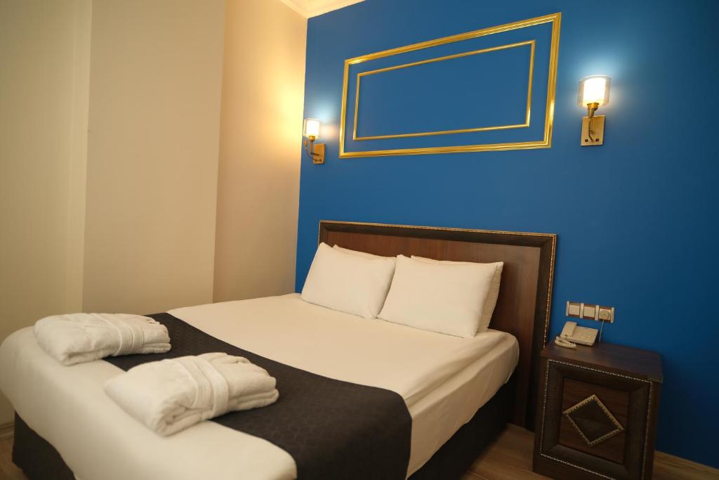 Postel nebo postele na pokoji v ubytování Malabadi Hotel