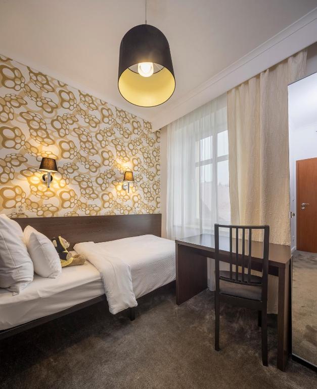 Postel nebo postele na pokoji v ubytování Pytloun Wellness Travel Hotel