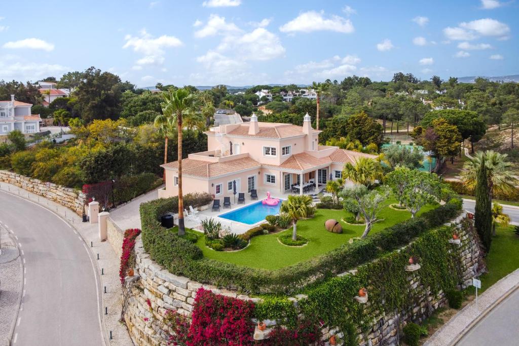 an aerial view of a house with a swimming pool at Extraordinary Villa on an elevated position in Quinta do Lago in Quinta do Lago