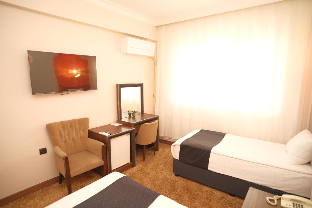 Postel nebo postele na pokoji v ubytování Malabadi Hotel