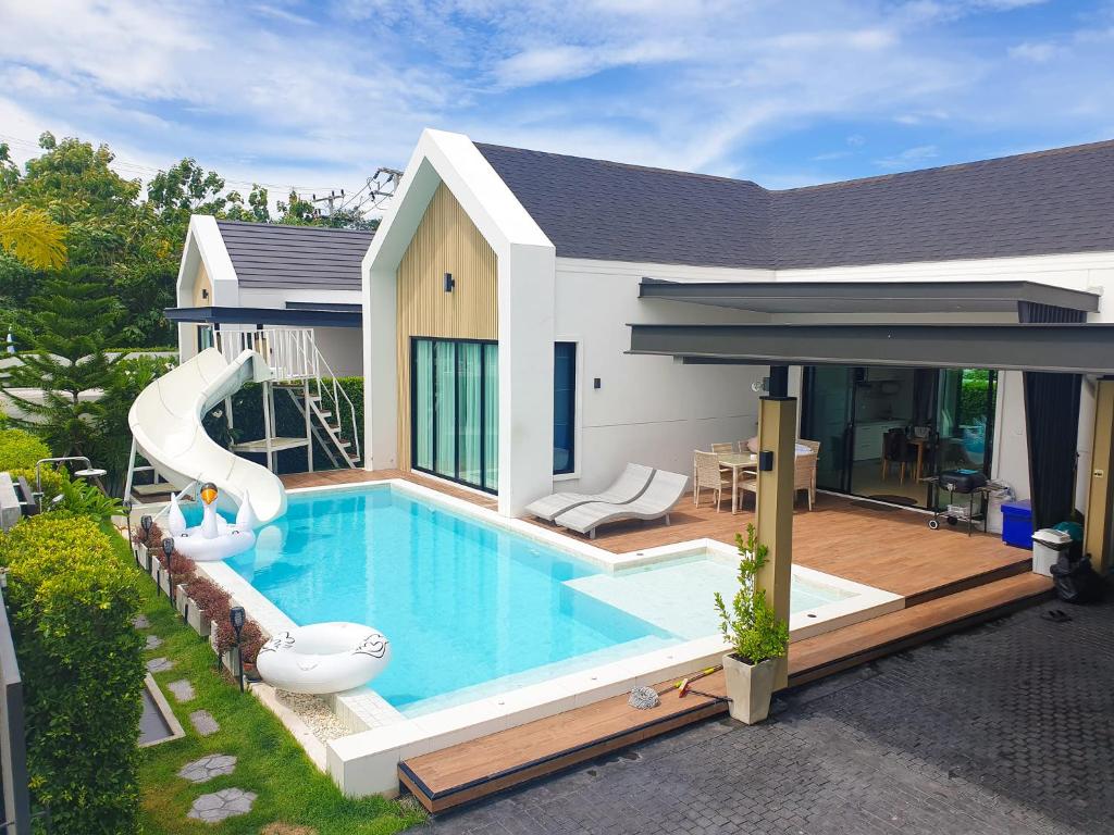 a house with a swimming pool with a slide at 22Pool villa Hua-Hin in Hua Hin