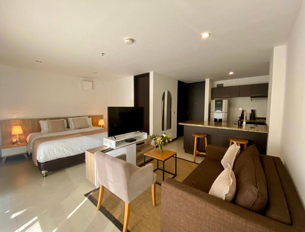 a hotel room with a bed and a living room at Room in Guest room - Elegant And Sophisticated Suite in Rionegro