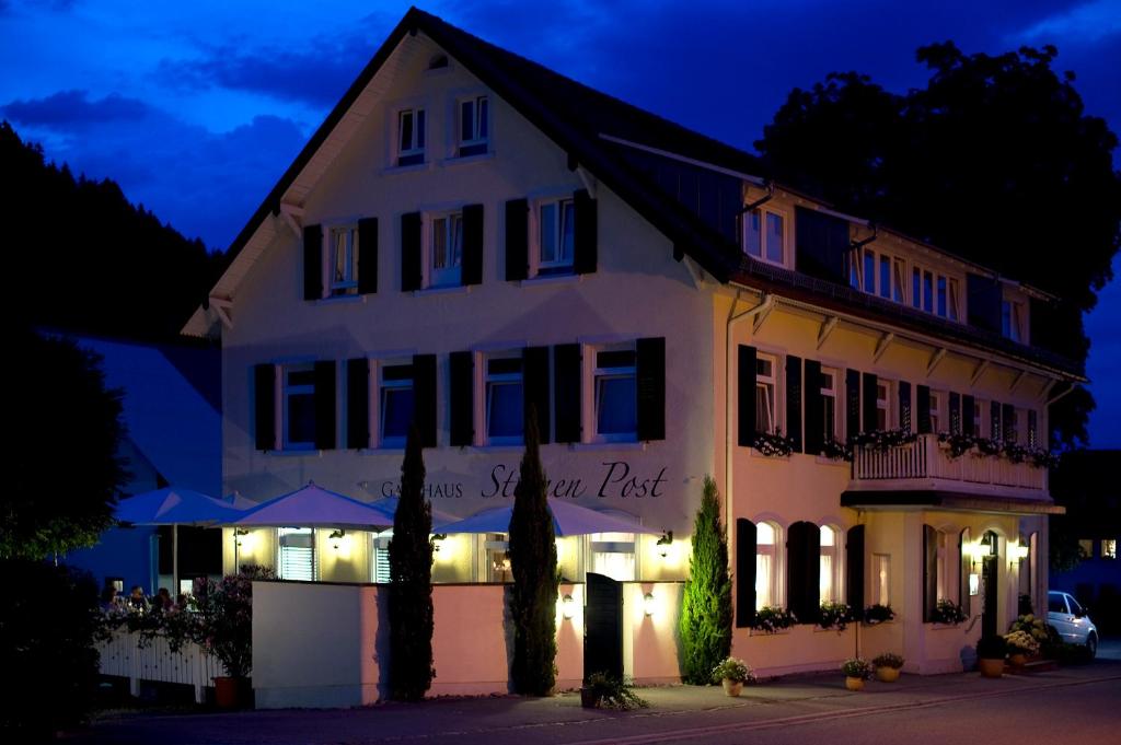a white building with a sign that reads guest post at Gasthaus Sternen Post in Oberried
