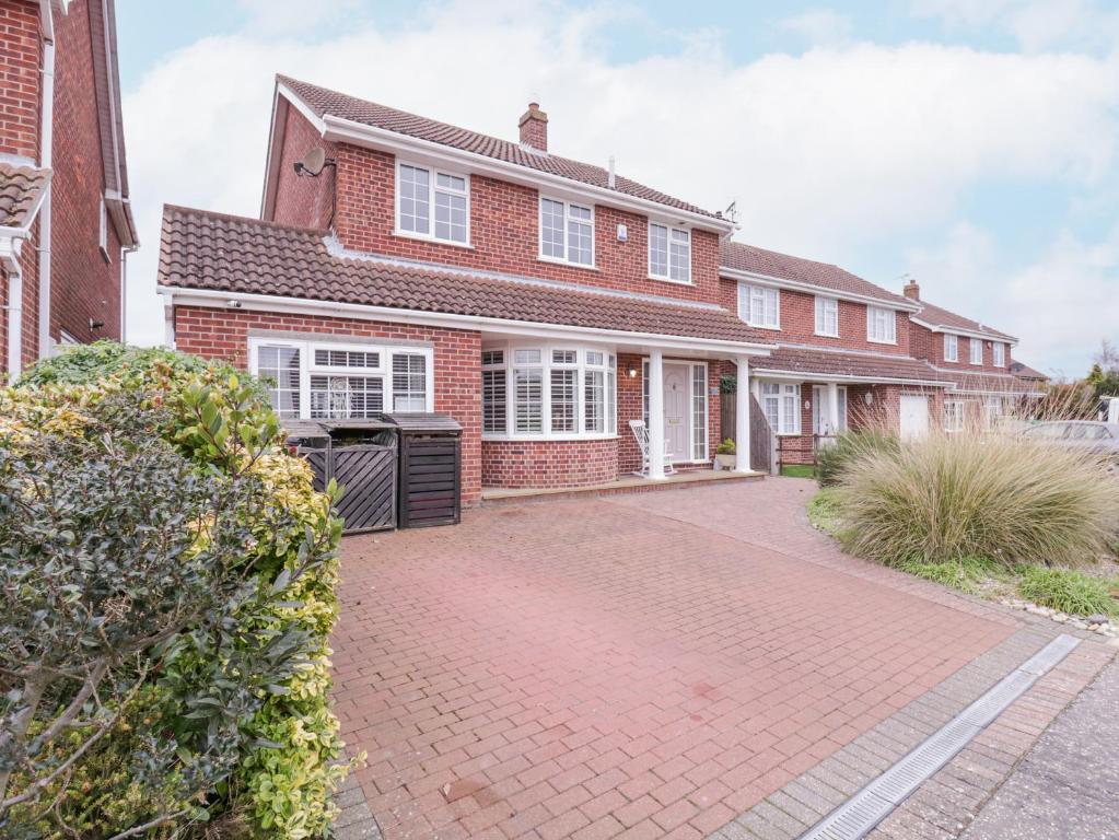 a red brick house with a brick driveway at Hide and Sleep in Walton-on-the-Naze