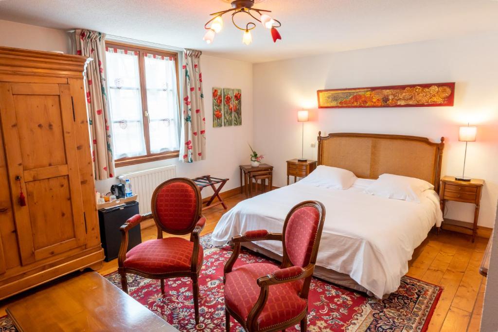 Postel nebo postele na pokoji v ubytování Hotel à l'Oriel