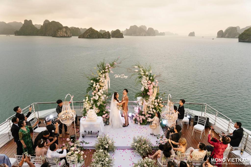a wedding ceremony on the deck of a boat at Grand Pioneers Halong Bay Cruise 1 in Ha Long
