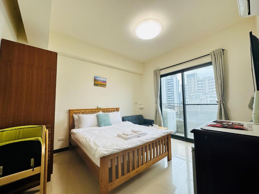 a bedroom with a bed and a large window at 新竹比斯 Hsinchu Peace in Zhubei