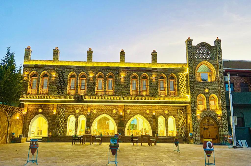 a large brick building with lights on it at New Abusimble 2 Hotel & Restaurant in Abu Simbel