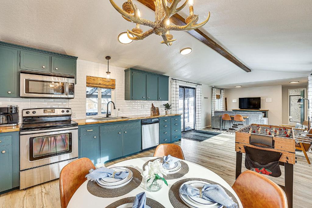 a kitchen with blue cabinets and a table with chairs at Downtown Cascade Vacation Rental Less Than 1 Mi to Lake! in Cascade