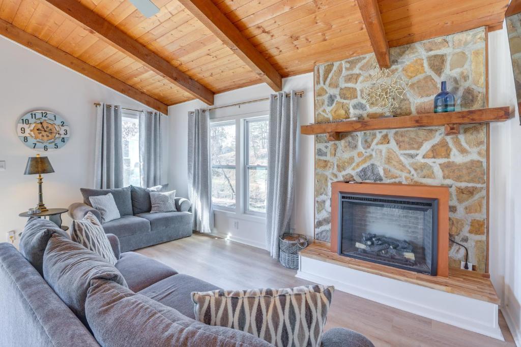 a living room with a couch and a fireplace at Waterfront Shelby Home with Fireplace and Scenic Decks in Shelby