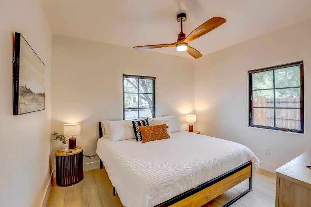 a bedroom with a bed and a ceiling fan at Sam Hughes Desert Oasis, Private Pool & Walk to UA in Tucson
