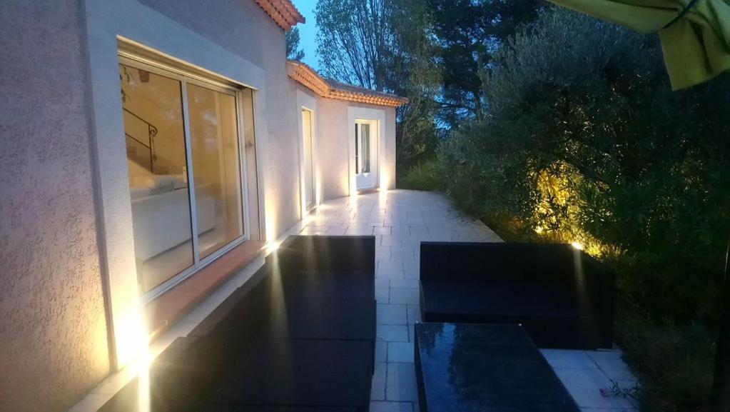 a walkway leading to a building with lights on it at 19 chemin de la carraire in Cadolive