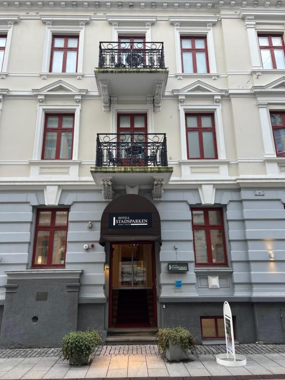 a white building with a door and a balcony at Hotell Stadsparken in Helsingborg