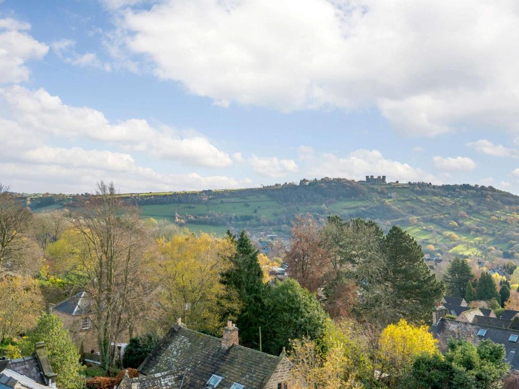 a view of a town with a castle on a hill at 3 Bed in Matlock 86048 in Matlock