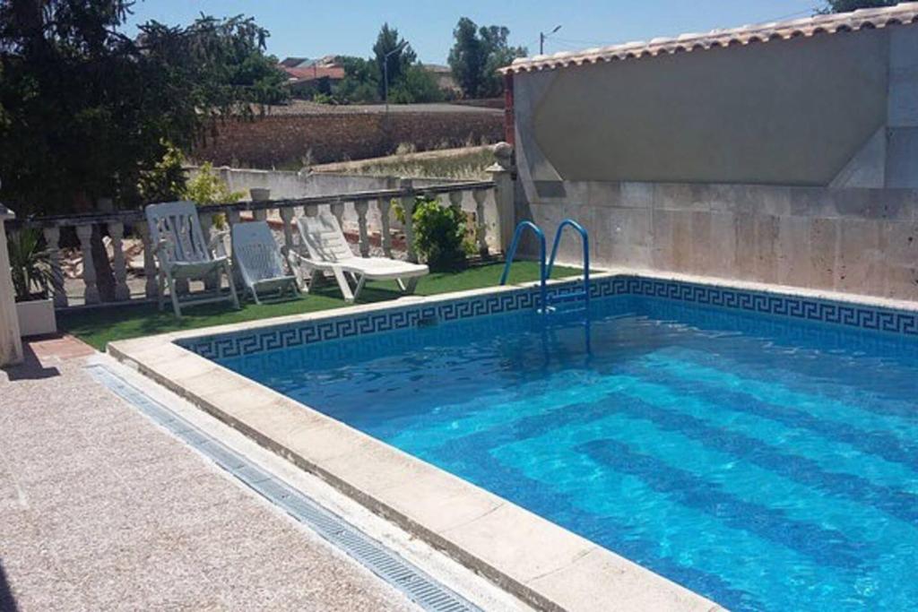 a large swimming pool with a pool at 3 bedrooms chalet with private pool terrace and wifi at La Almarcha in La Almarcha