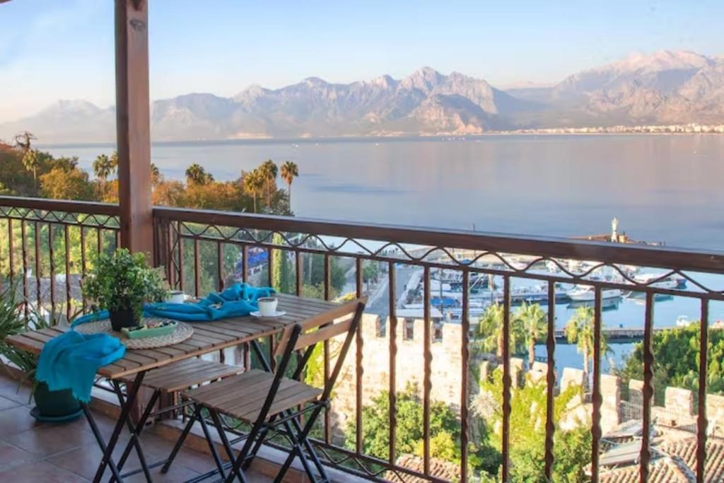 a balcony with a table and a view of the water at Mavi Avlu - Old town apartments in Antalya