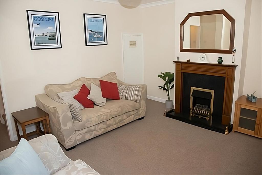 a living room with a couch and a fireplace at Breakfast With A View Free Parking and Water Access in Wallington