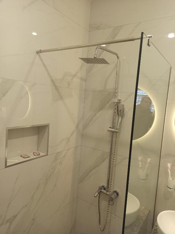 a shower with a glass door in a bathroom at Посуточный гостевой дом in Gyumri