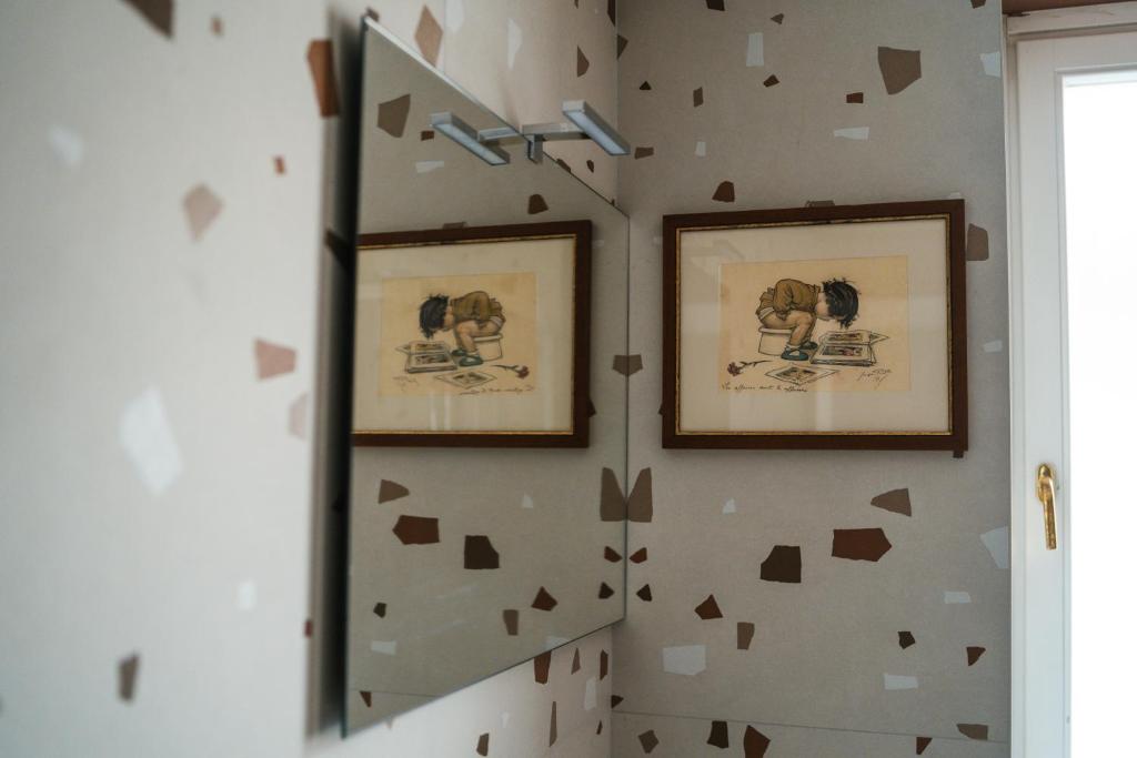 a room with two pictures of elephants on the wall at Hurban Apartments Muggia in Muggia